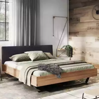 Nowoczesne łóżko Hyge stworzone dla wielbicieli nieszablonowych wnętrz  Łóżko Hyge to odzwierciedlenie elegancji,  której ekskluzywność sprowadza się do tapicerowanego zagłówka w połączeniu z solidnym drewnem. Szeroki pas tapicerki nie t